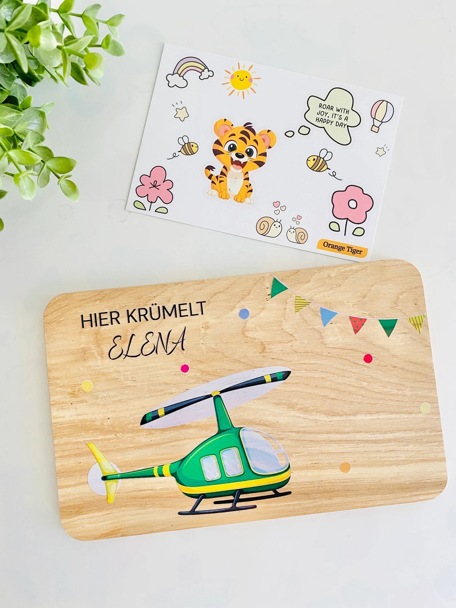 wooden breakfast board featuring green helicopter, colorful garlands.