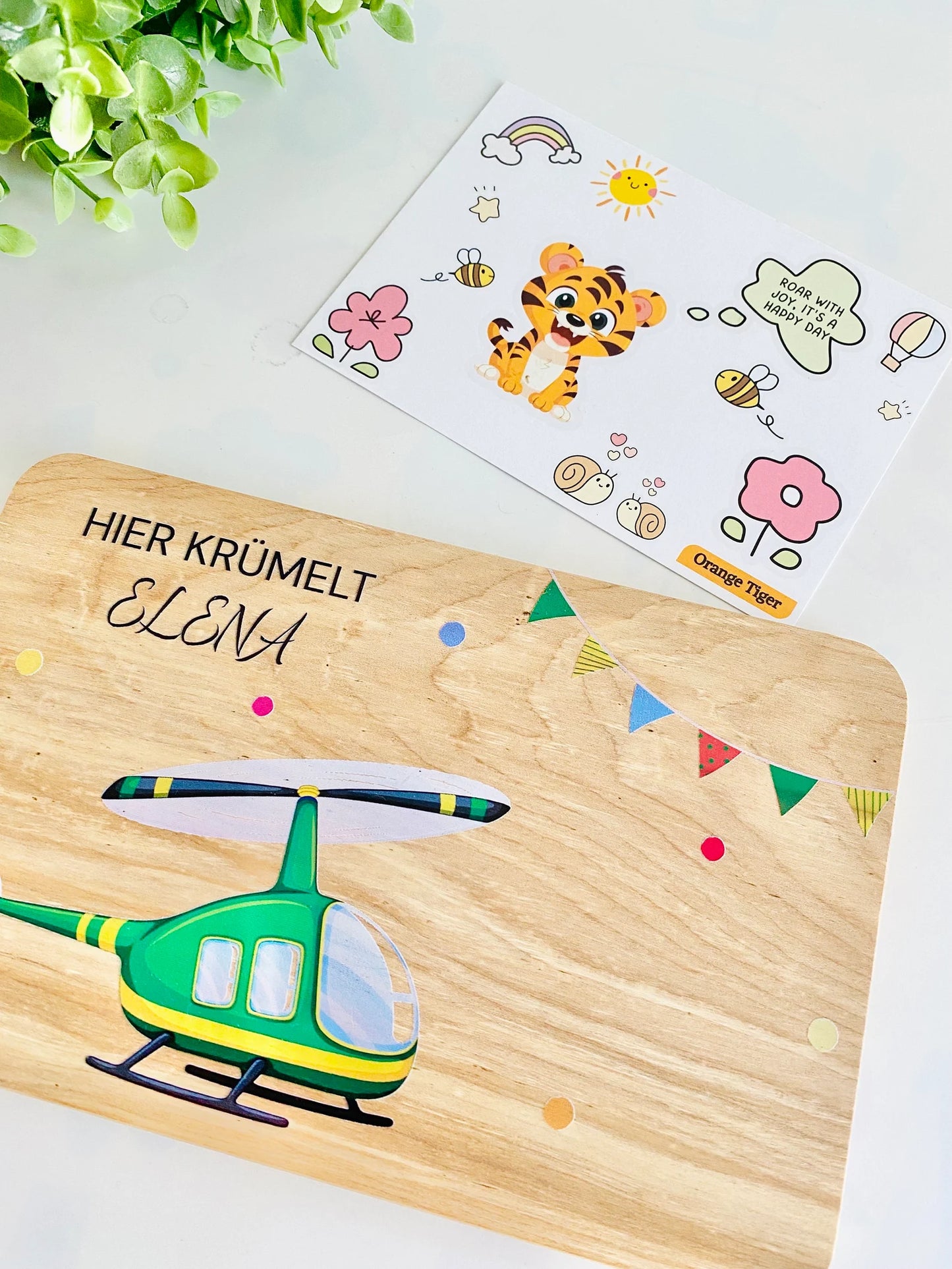 kids snack board with a green helicopter and Hier Krümelt written on the top.Miracle gift, baby gift