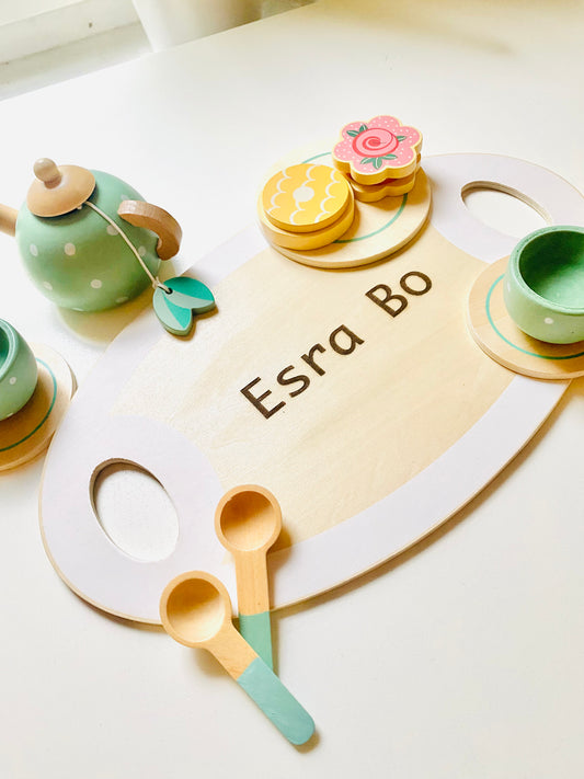 A wooden tea party set in green with cups, kettle, snacks and serving tray. Toy for kids 1 year or older